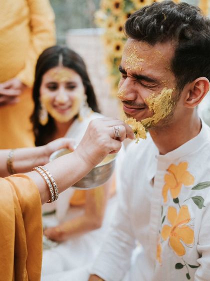 A playful moment during the Haldi ceremony. The groom's expression is priceless, and it's these candid reactions I love to capture.