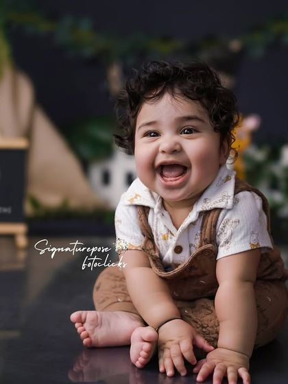 A close-up of the happy nine-month-old, his joy lighting up the entire jungle-themed set.