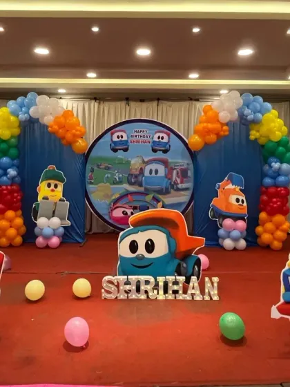 All aboard for a fun construction truck themed party. This setup is perfect for little vehicle lovers, featuring a custom backdrop and large cutouts of colorful, friendly trucks, framed by bright balloon arches.
