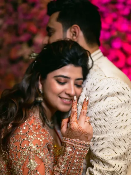 A tender moment of love and victory after the ring ceremony. The bride's hand, now with the ring, shows her joy.