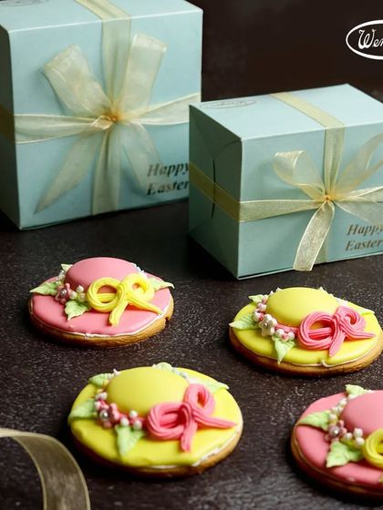 Our special Easter Bonnet cookies. These sugar cookies are decorated with colourful icing to look like festive spring hats, a unique and charming treat.