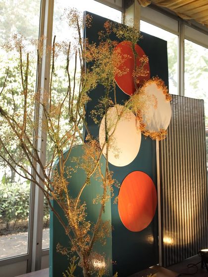 A modern and artistic backdrop for a Sehra Bandi ceremony, using geometric shapes, textures, and a color palette inspired by autumn.