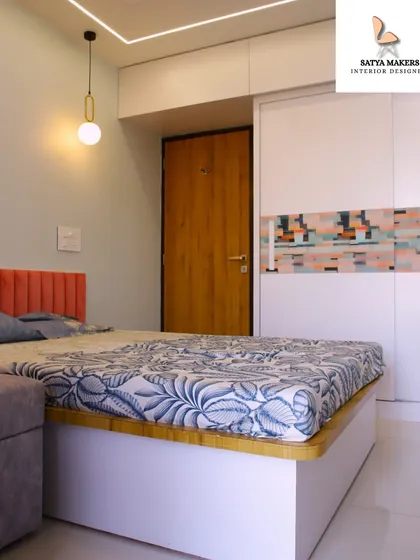 A modern kids' room with a coral-colored headboard and a unique patterned wardrobe, showcasing a playful use of color and design.
