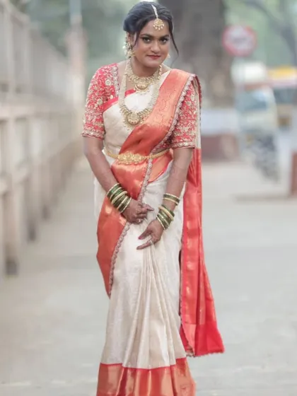 A full-length outdoor shot of the Telugu bride. The pre-pleated saree maintains its structure and elegance, proving perfect for wedding photography.