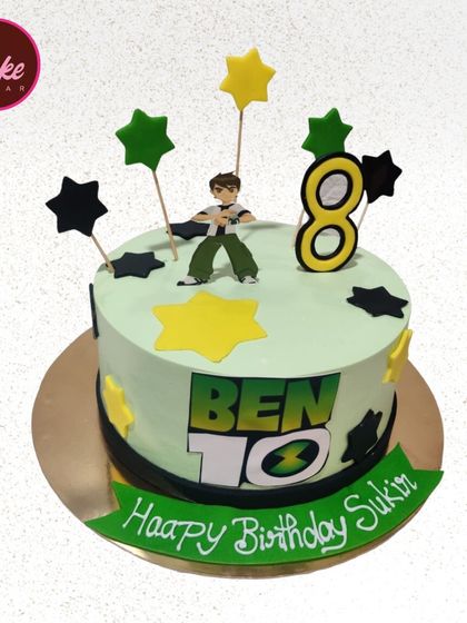 Another fun Ben 10 cake design, this one for an 8th birthday. It features a Ben 10 figurine and is decorated with stars in the classic green, yellow, and black color scheme.