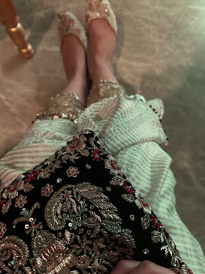 A close-up on the details. For this festive look, I paired an embroidered potli bag with beautiful juttis and payals, showing how accessories complete an outfit.