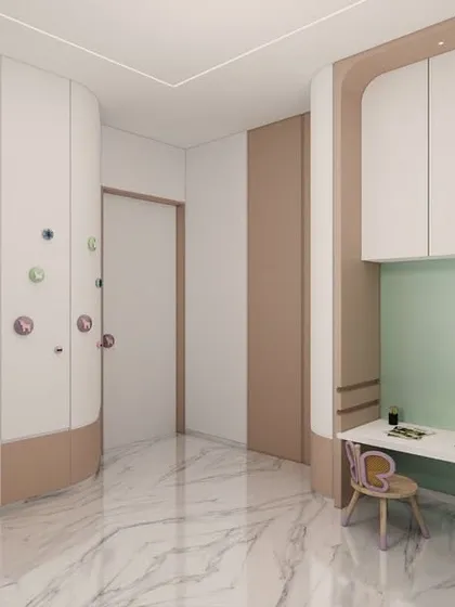 This kids' room features a playful and interactive wardrobe with colorful, oversized knobs that can be used for climbing. The design includes a built-in study nook with butterfly-themed chairs, making it a space that encourages both play and learning.