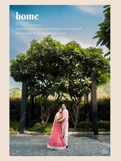 Devanshi and Sarang chose beautiful pink outfits for their Haldi. This wide shot under a tree defines 'home' as being surrounded by love.
