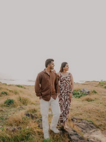 A stylish shot of the couple looking out towards the horizon. This pose has a thoughtful, adventurous feel, as if they are looking towards their future together.