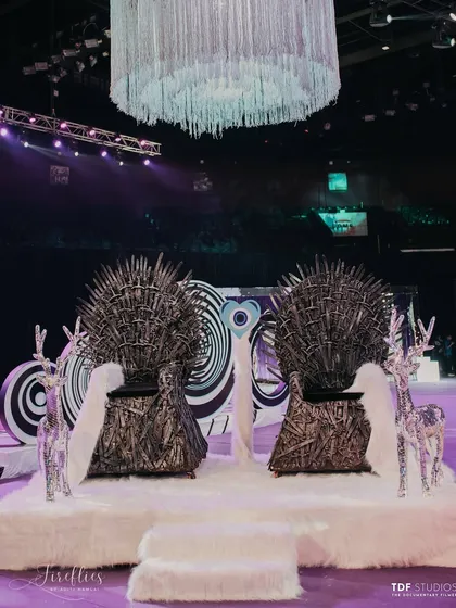 A fun and bold seating area for the couple, featuring two 'Game of Thrones' inspired iron throne replicas. This was a playful nod to the couple's personality within the larger-than-life Sangeet theme.