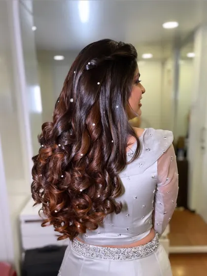 Glamorous curls for a sangeet night. I scattered pearls throughout the hair to add a touch of sparkle and magic to these beautiful, bouncy curls.