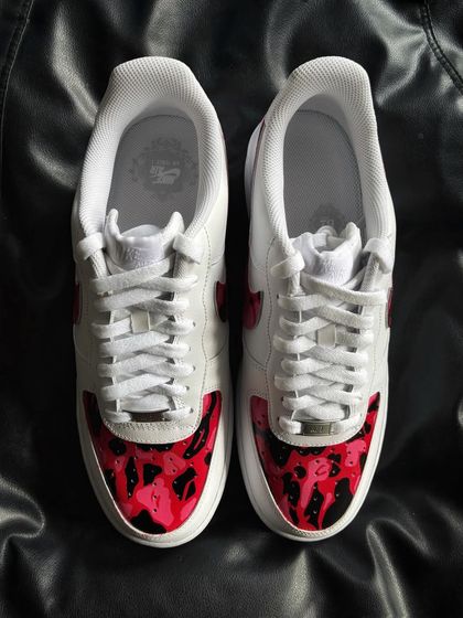 A front view of the red camo custom sneakers.
