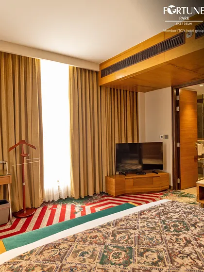 A view of the room's layout, showing the ample space, television, and valet stand. We provide these conveniences to make your stay as smooth as possible.