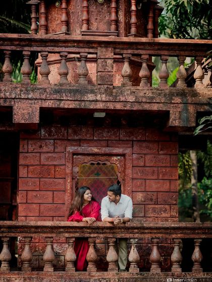 The couple shares a conversation on the temple balcony. This candid shot captures their easy rapport and the beautiful architectural details of the location.