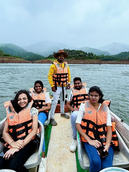 A group enjoying a boat ride in Wayanad, with our trip captain making sure everyone has a great time.
