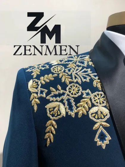 A close-up on the intricate gold zardozi work on the shoulder of the teal tuxedo. This highlights the traditional Indian embroidery techniques I use in my modern designs.