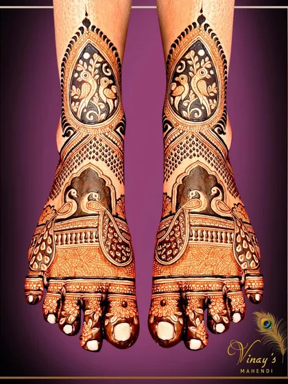 A bold and beautiful feet design with birds framed in paisley shapes. The dark henna application creates a stunning contrast, making the motifs stand out.