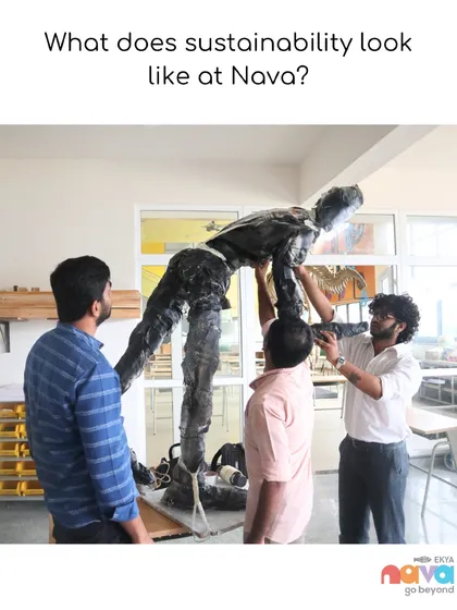 Instructors and students work together to assemble a large sculpture. This behind-the-scenes shot shows the collaborative effort and dedication that goes into creating large-scale, meaningful art projects at Ekya Nava.