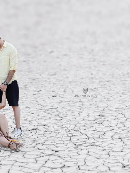 A unique shot on the cracked earth of a dry lakebed in Tehri. This dramatic landscape provides a stark and beautiful contrast for a romantic portrait.