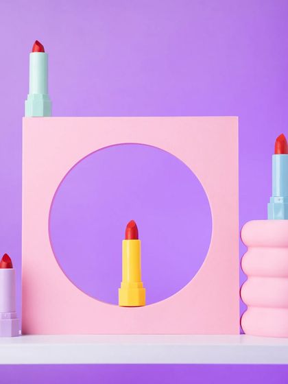 A creative and architectural composition of colorful lipsticks using geometric props. This style is modern, artistic, and makes the product look like a piece of art.