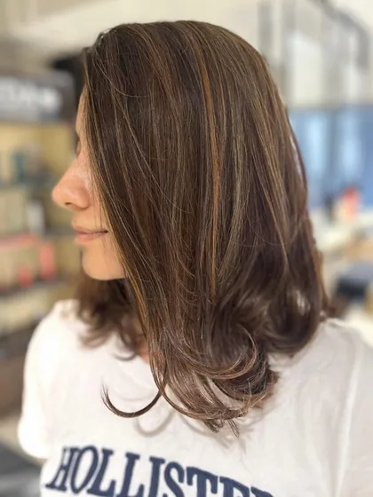 A warm caramel balayage blend on a mid-length cut. This look is a great example of a color transformation from red to a beautiful, warm brown.