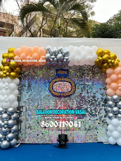 This naming ceremony backdrop makes a statement with a shimmering sequin wall. The balloon arch in peach, white, and chrome gold adds a touch of glamour to this outdoor setup.