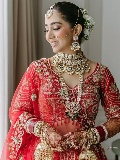 A serene portrait of the bride, her eyes closed, showcasing her flawless makeup and stunning jewelry.