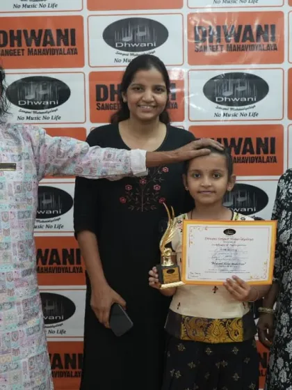A student with her family and our senior guru at the prize ceremony.