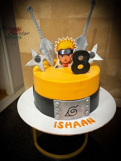 For the anime fan, this Naruto-themed cake captures the spirit of the series. The design features the iconic headband logo and other symbols, with sharp orange and black colors on a buttercream base.
