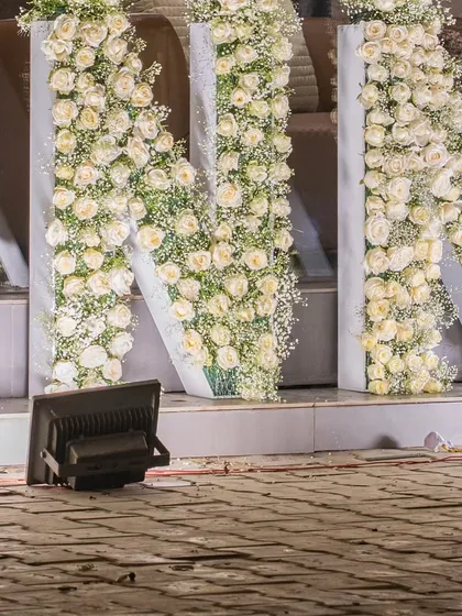 A closer look at the 'N' and 'N' of the floral brand name installation, highlighting the sheer volume of flowers used.
