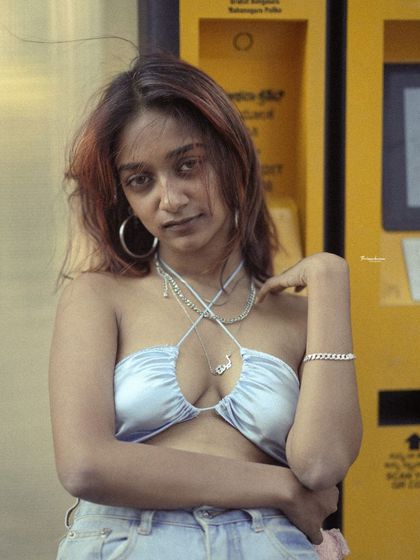 A close-up street portrait with an intense, direct look. The focus is entirely on the subject's expression, creating a powerful and engaging image.