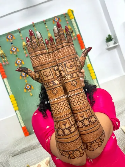 A full view of a bridal backhand design with initials and elephants.