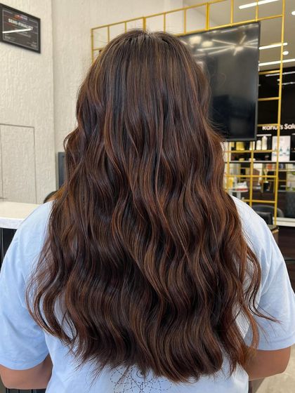 A closer look at the richness of chocolate brown locks. The color is deep and even, with a beautiful shine that reflects the light.