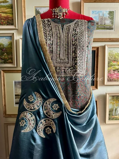 This ensemble showcases a masterful blend of textures and traditions. A modal silk kurta featuring intricate Gota Patti and Marodi hand embroidery is paired with a lustrous Italian silk organza dupatta, adorned with celestial moon motifs.