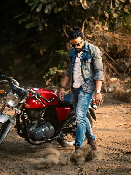 A dynamic shot with a Royal Enfield motorcycle. The dust kicking up adds a sense of action and adventure.
