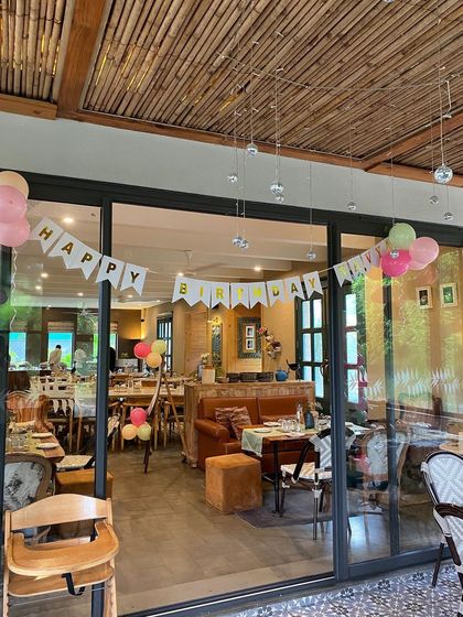 A 'Happy Birthday' banner hanging in the panda-themed party venue.