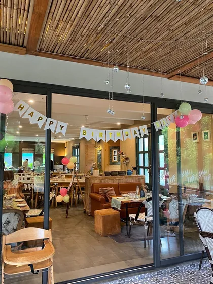 A 'Happy Birthday' banner hanging in the panda-themed party venue.