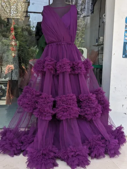 A look at our new purple ruffle gown on a mannequin in our store. This design is also available as a mother-daughter matching set.