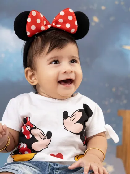 The happiest smile from our little Minnie Mouse fan. We have a variety of fun character themes, and this one captures the pure joy of childhood magic.