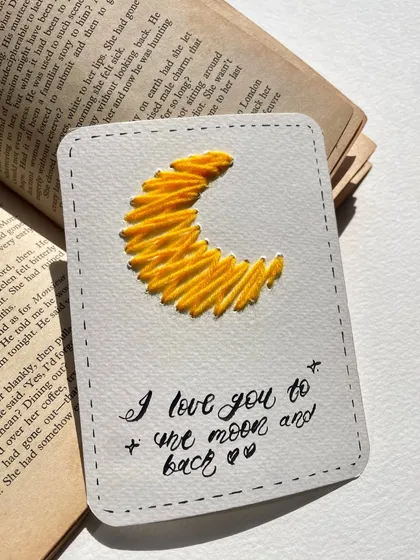 "I love you to the moon and back." A classic sentiment paired with a hand-embroidered crescent moon. Simple, sweet, and heartfelt.