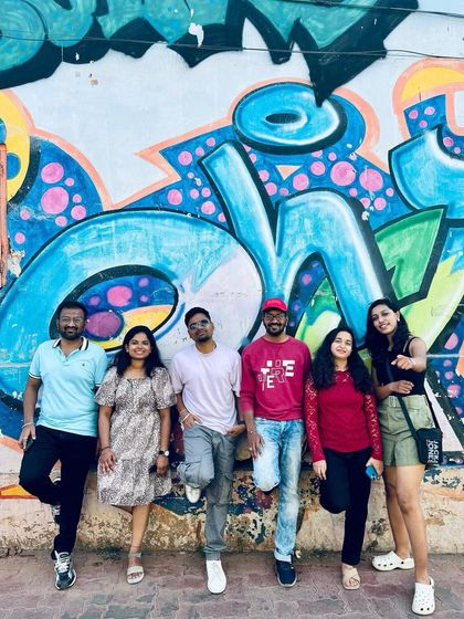 Posing against the vibrant street art in Kannur. Our trips are not just about nature but also exploring local culture and art.