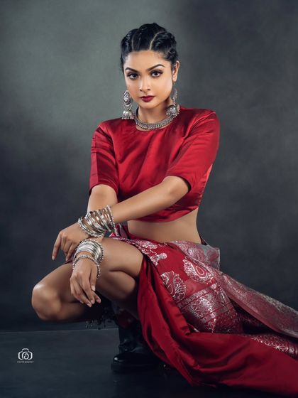 A powerful crouching pose that adds an athletic, modern edge to the traditional saree. This shot is all about attitude and breaking fashion boundaries.