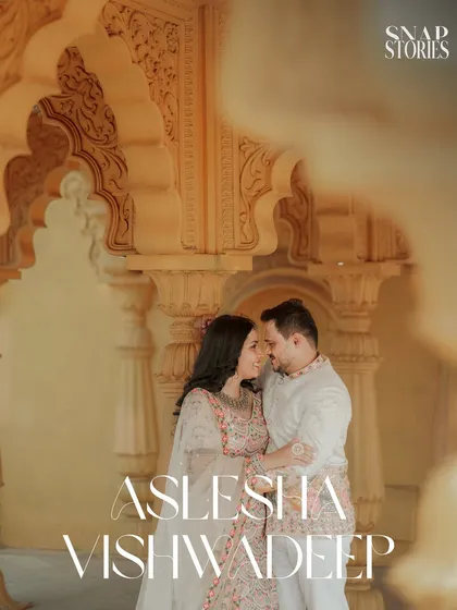 An intimate close-up of the couple, framed by the soft, warm tones of heritage architecture. This highlights their connection amidst the grandeur of the location.