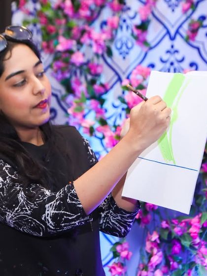 Our art instructor provides a demonstration to guide the young artists through their canvas painting.