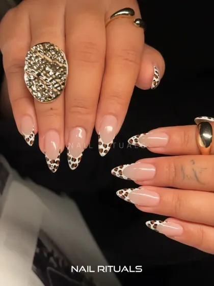 A full view of this wild and chic set. The cow print tips paired with bold gold jewelry create a look that is both trendy and timeless.