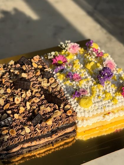 Another view of the popular chocolate and floral vanilla half and half sheet cake, showing the distinct layers and textures of each side.