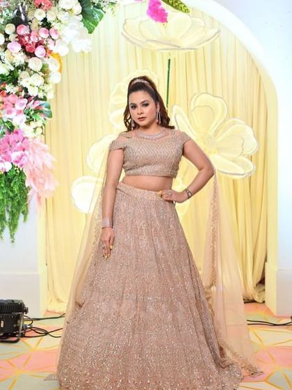 Another happy client posing in the popular champagne gold lehenga.