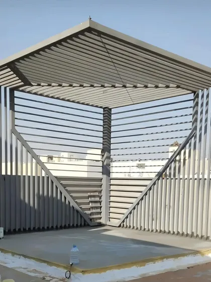 This uniquely shaped pergola features slatted walls and a raftered roof, creating a sculptural, almost futuristic look. It demonstrates our ability to fabricate bold, unconventional designs that make a strong architectural statement.