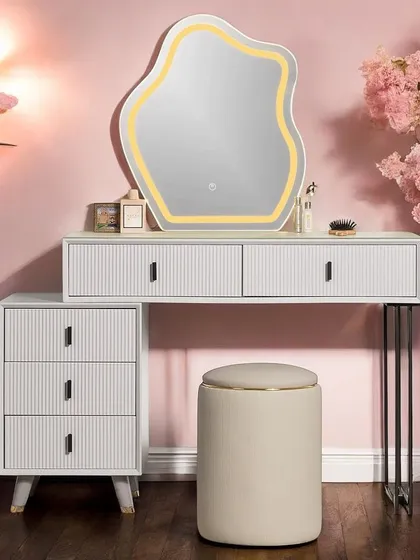 Another view of our elegant vanity set, complete with a comfortable pouf and an organically shaped LED mirror. The combination of clean lines and textured surfaces creates a sophisticated look for any bedroom.