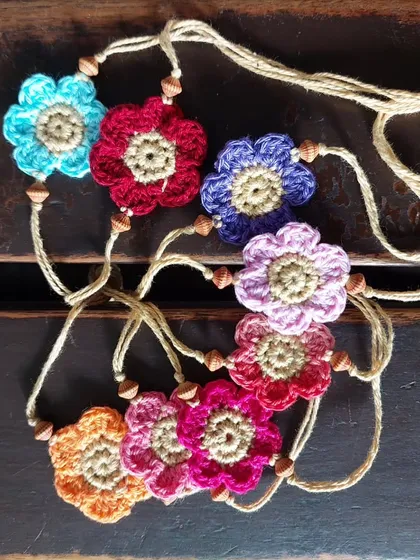 A collection of colorful flower rakhis, each one unique.
